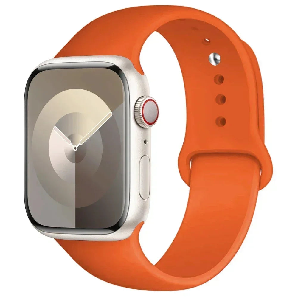 An Apple Watch in a silver case with an orange silicone sport band.