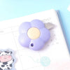 A purple floral design letter opener and paper cutter resting on a monthly planner page.