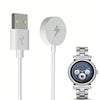 A white magnetic wireless charging cable and a silver smartwatch are shown.