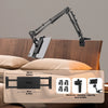 A black adjustable tablet holder with a long arm is shown mounted on a wooden surface.