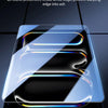 A close-up view of a clear tempered glass screen protector being applied to an Apple iPad screen.