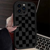 A black silicone phone case with a checkered pattern is shown being held by a hand against a laptop.
