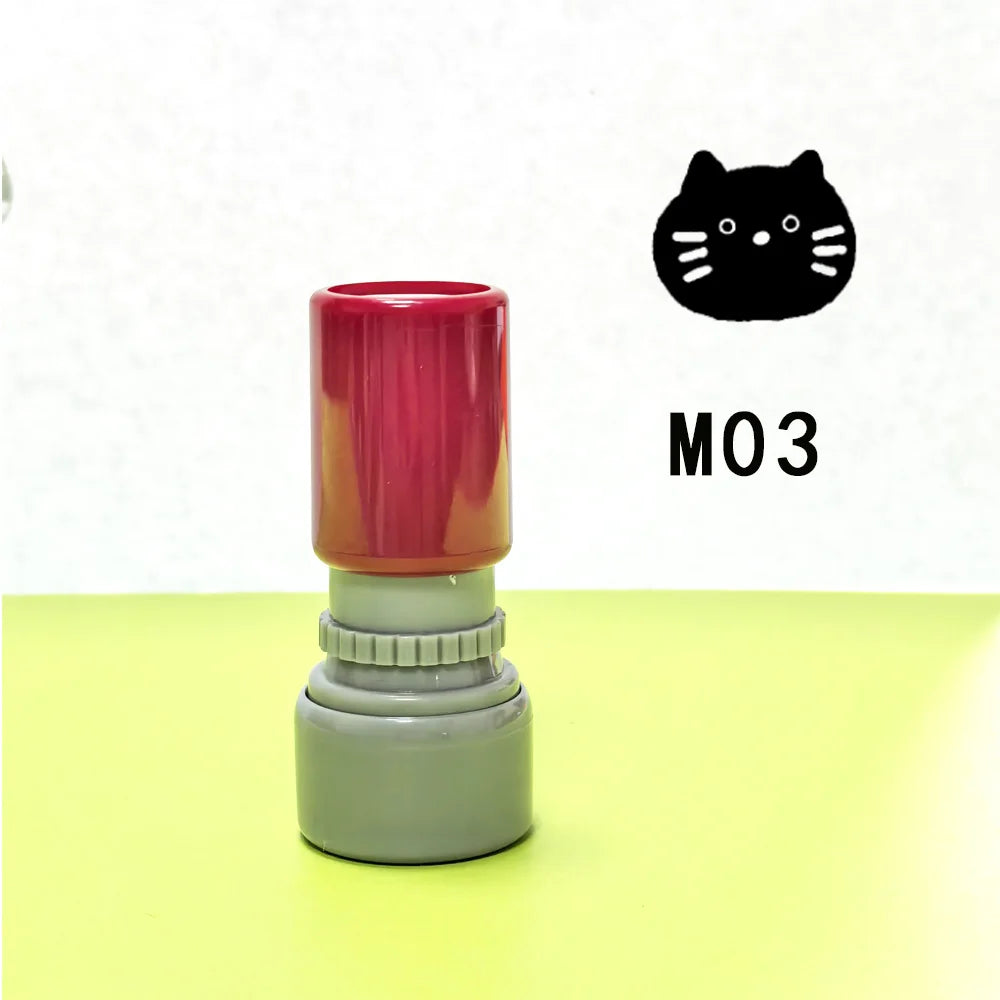 A set of three colored stamps, including a red one with a black cat pattern, is displayed on a light green surface.