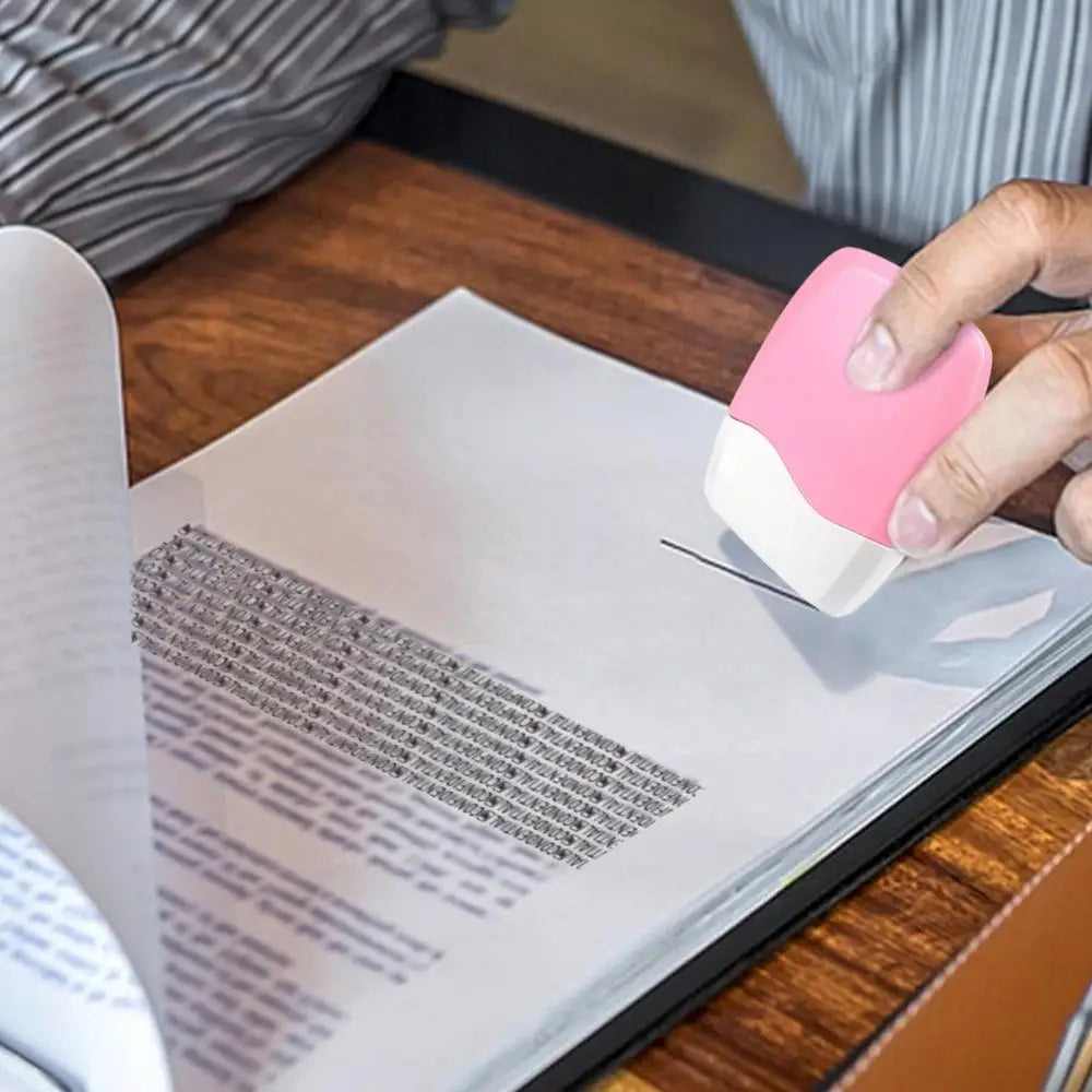 A hand is applying a pink roller stamp to a document, demonstrating reusable identity theft protection stamps.