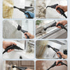 A hand is using a black handheld steam cleaner to clean a tiled wall surface.