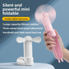 A hand holds a pink portable foldable mini fan with a large battery and adjustable wind speed, next to a white version.