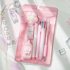 A pink plastic pouch containing a cute cartoon school stationery set including pens and accessories.