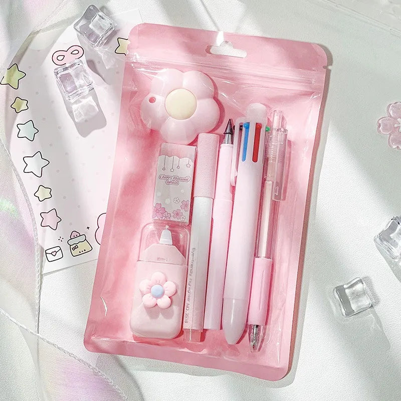A pink plastic pouch containing a cute cartoon school stationery set including pens and accessories.