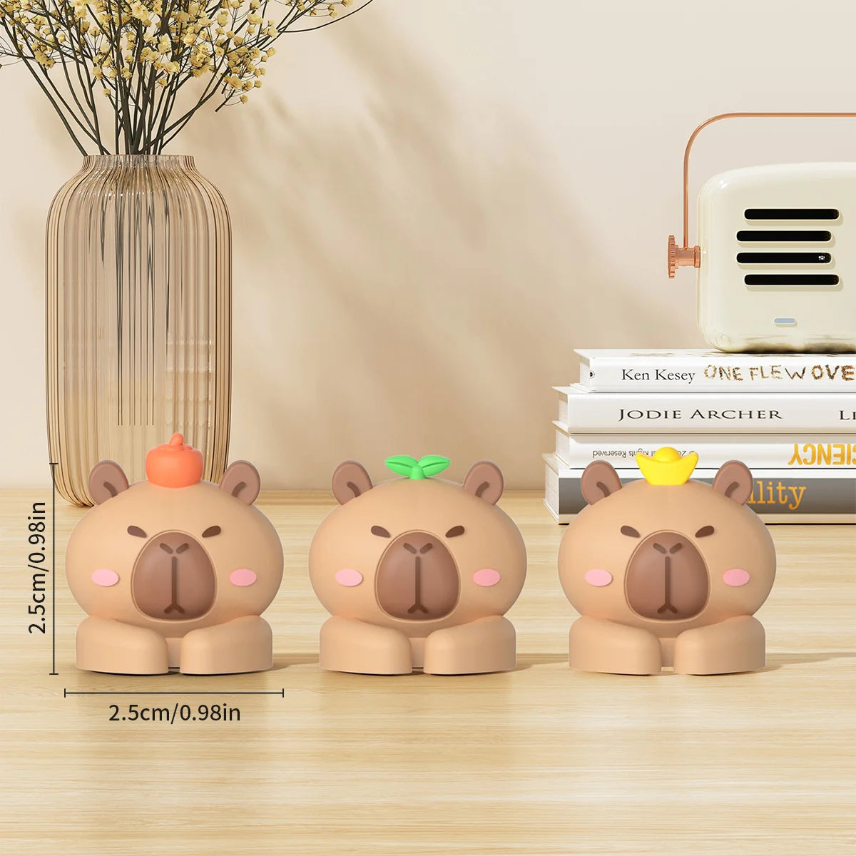 Three cute bear-shaped desk cable organizers in peach and beige colors displayed on a wooden surface.