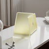 A light yellow durable hard shell laptop case for a MacBook shown on a white table.