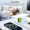 A green GaN fast charger and its retractable cables are shown next to a smartphone on a white surface.