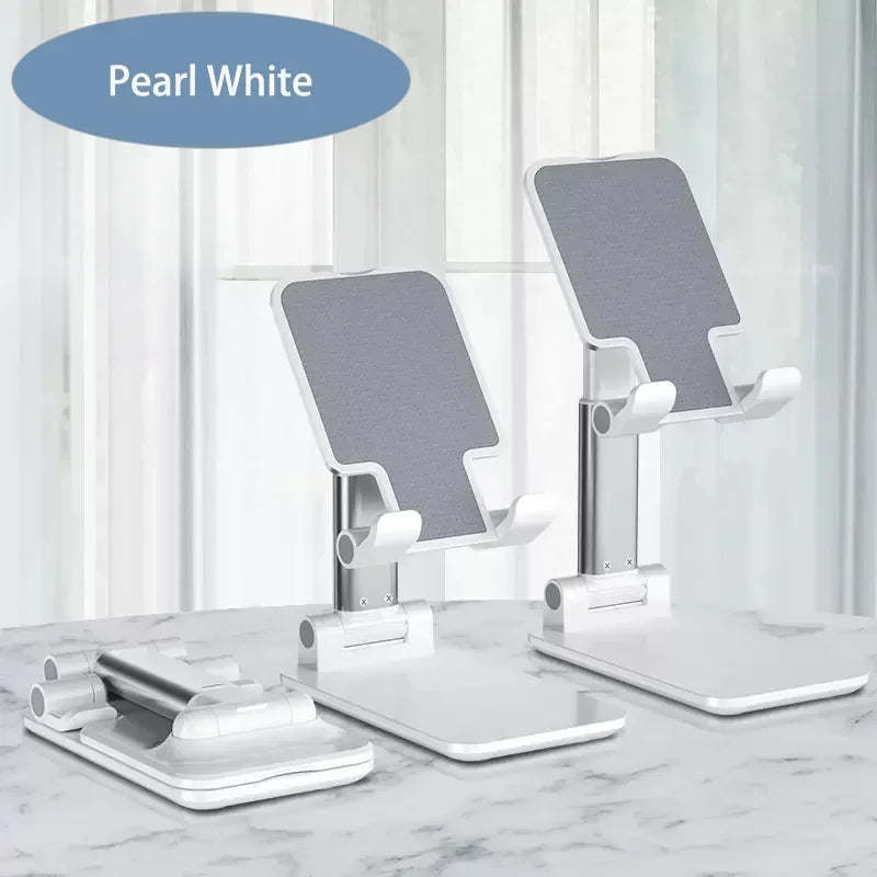 A set of pearl white foldable adjustable phone holder stands displayed on a marble surface.