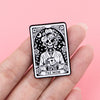 A black and white tattoo-style enamel pin featuring a skull holding a coffee cup, labeled The Mom.