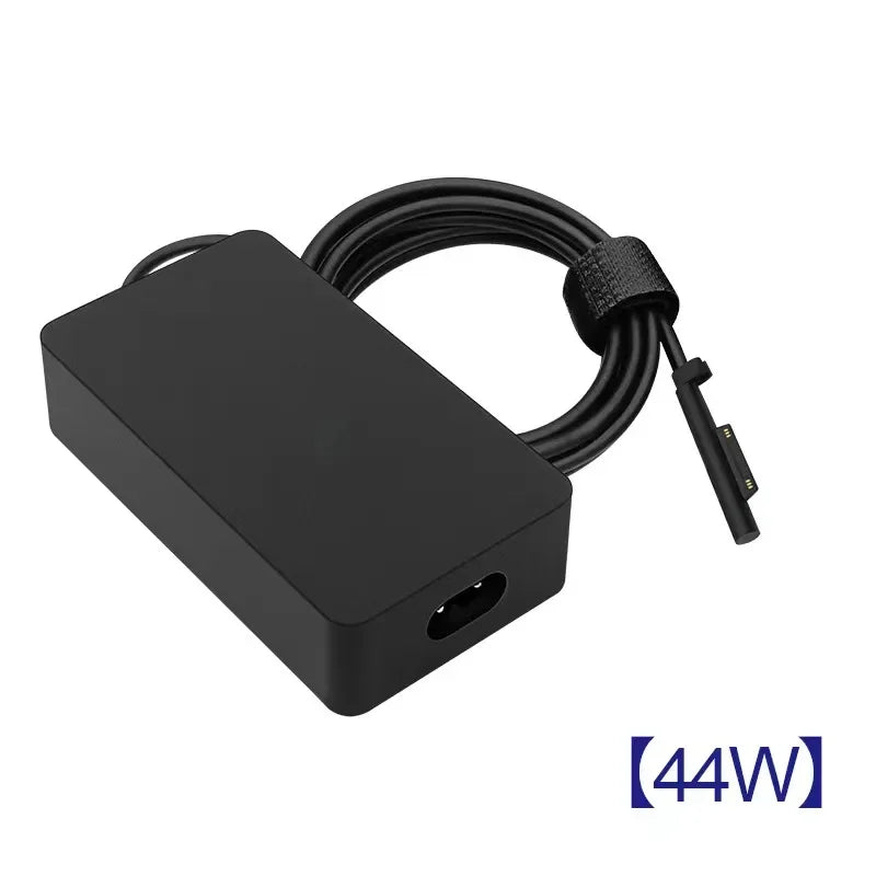 A black universal tablet charger with a coiled cable and a connector is shown against a white background.