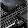 A close-up view of a black braided lightning cable connecting an iPhone to a charging port.