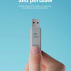 A hand holds a small, lightweight USB 3.0 SDXC card reader device against a light blue background.