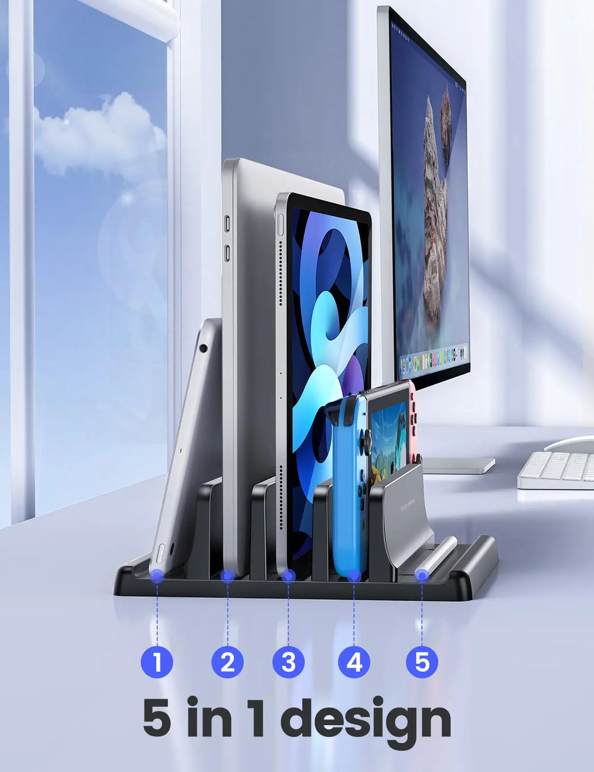 A black organizer holds five devices including a laptop and smartphone in a vertical stand design.