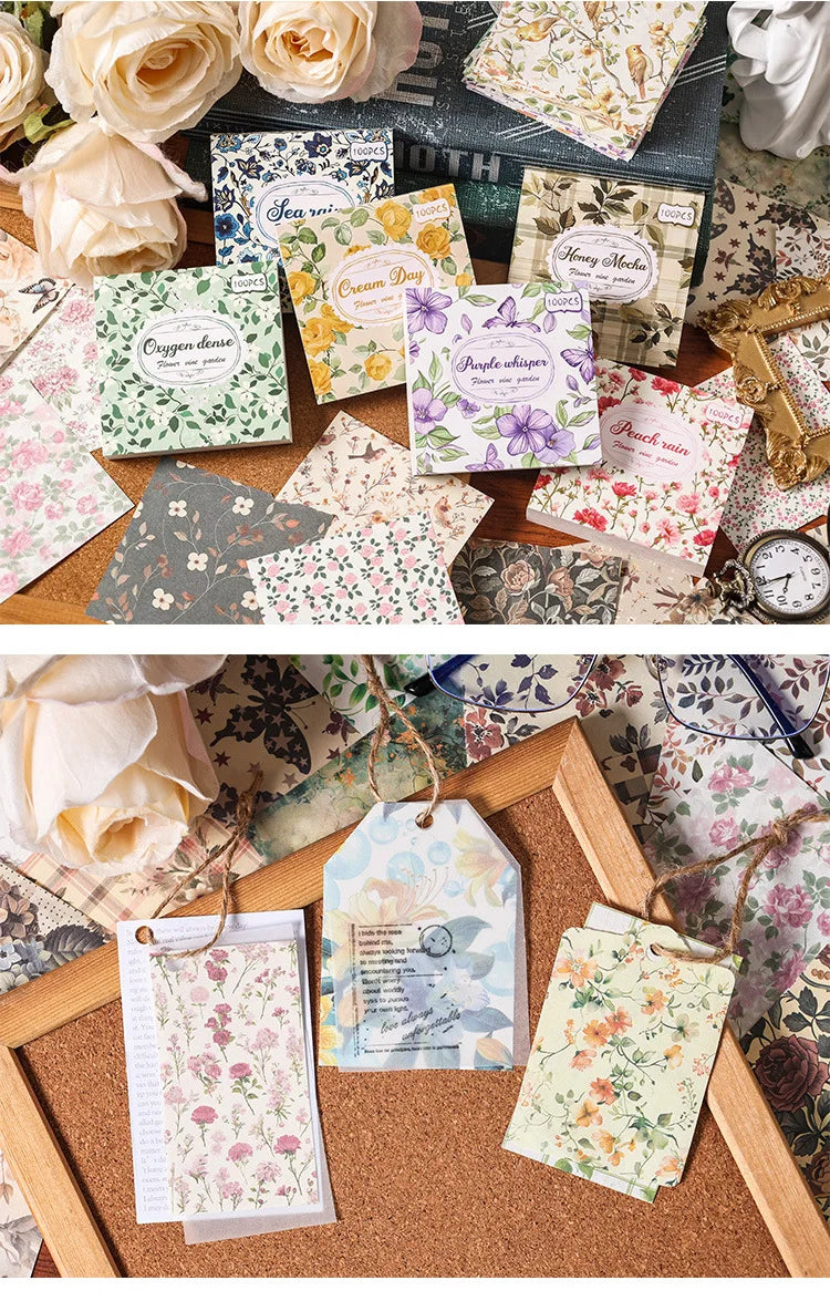 A collection of vintage floral square scrapbook paper sheets in various pastel and muted tones displayed on a wooden board.