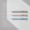 Three precision gel pens in white, pink, and light blue are displayed against a white background.