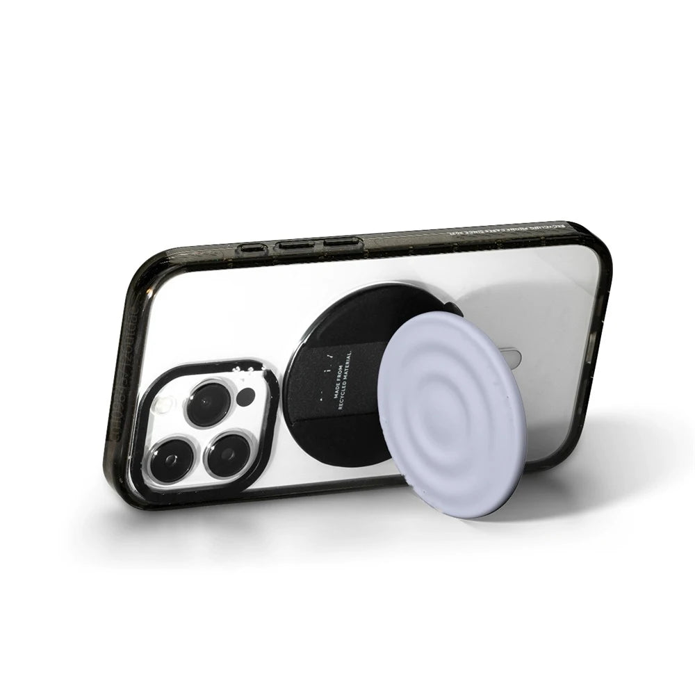 A black smartphone is shown with a white silicone grip and magnetic stand attached.