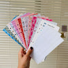 A stack of colorful A6 budget planner sheets with envelope pockets and expense sheets