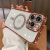 A hand holds a glitter diamond magnetic wireless phone case with a clear back and rose gold frame.