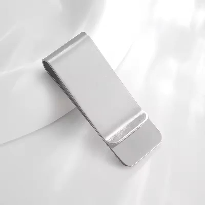 A silver vintage solid brass money clip with a card holder shown in a close-up view.