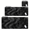 Black abstract desk mat with swirling white lines and a white mousepad visible on the side