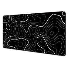 Black abstract art desk mat featuring white contour lines on a non-slip rubber base