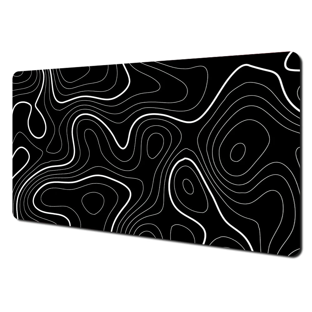 Black abstract art desk mat featuring white contour lines on a non-slip rubber base