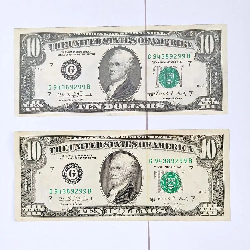A pair of United States Federal Reserve notes, both valued at ten dollars, showing the denomination and serial numbers.