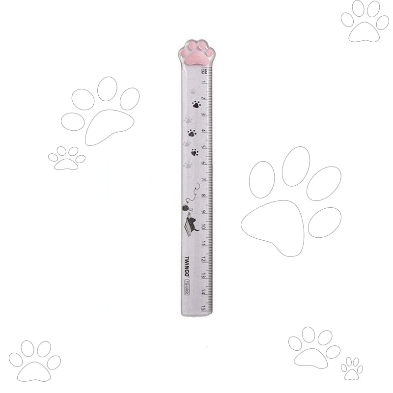 A plastic ruler shaped like a cat paw, used for measuring.