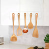 A collection of wooden spatulas and a metal spatula are displayed against a white kitchen cabinet background.