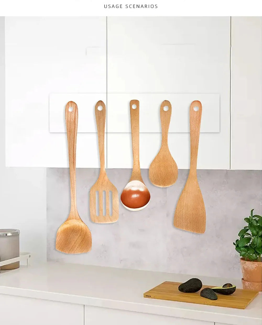A collection of wooden spatulas and a metal spatula are displayed against a white kitchen cabinet background.