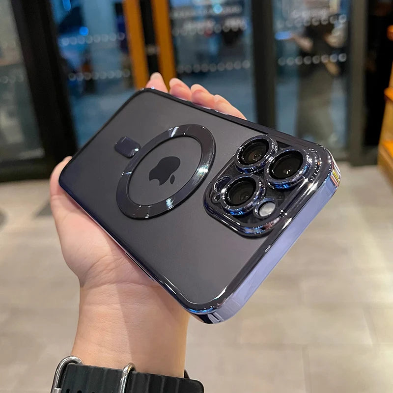 A hand holds a dark purple magnetic clear case with a plated finish for a MagSafe iPhone.