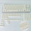 Colección de keycaps con degradado contorno blanco para teclado mecánico, mostradas en varias disposiciones.