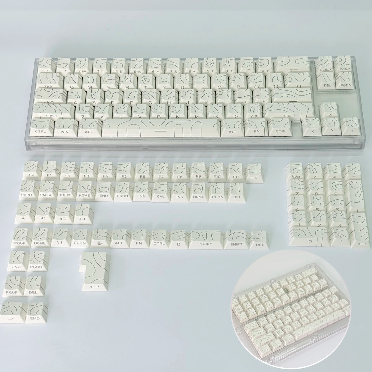 Colección de keycaps con degradado contorno blanco para teclado mecánico, mostradas en varias disposiciones.