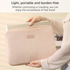 A person holds a light pink laptop sleeve designed for commuting or travel.