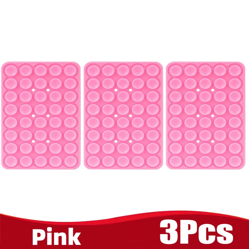 Three pink silicone suction cup phone holders