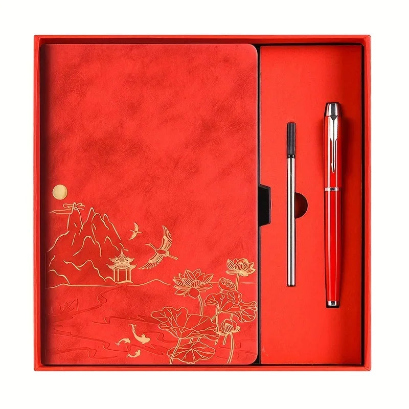 A red box containing a luxury notebook set with a silver pen inside.