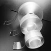 Rolls of heavy duty nano double-sided adhesive tape displayed on a dark surface.