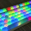 Close-up view of a mechanical keyboard with custom profile keycaps featuring bright RGB lighting.