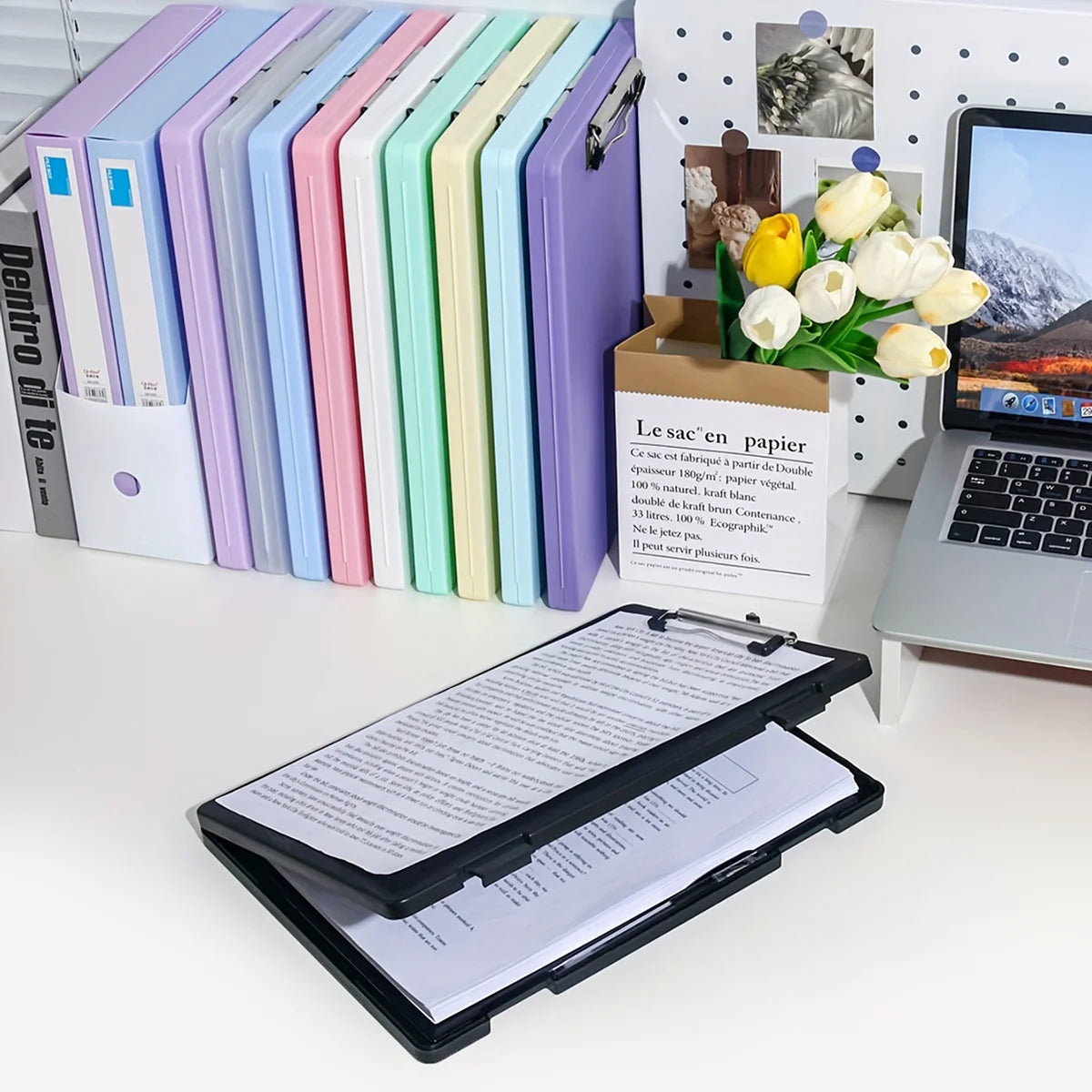 A set of colorful A4 document and photo storage file boxes arranged in a row next to a laptop.