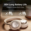 A pair of beige JBL headphones resting on a wooden surface with battery life information displayed nearby.