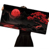 A large silicone gaming mouse pad featuring a dramatic red moon and dark landscape with vibrant red foliage.