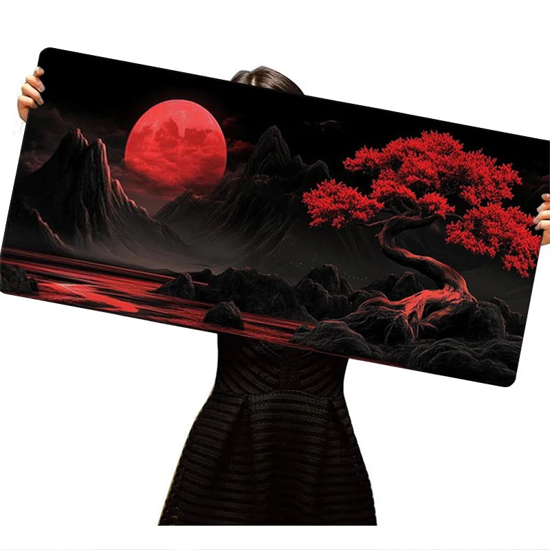 A large silicone gaming mouse pad featuring a dramatic red moon and dark landscape with vibrant red foliage.
