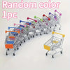 A row of metal shopping carts with various colored handles and baskets, used as a random color desktop organizer.