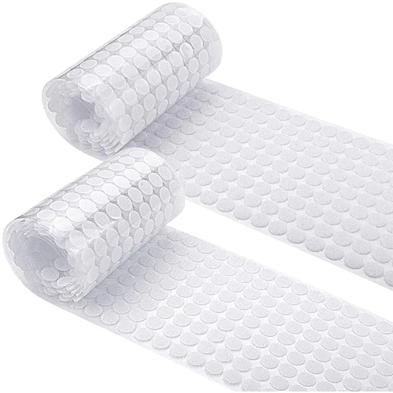 Rolls of white self-adhesive hook and loop fasteners for securing items