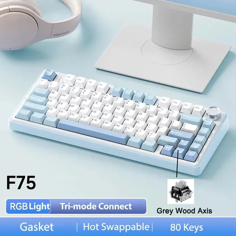 A white mechanical keyboard with light blue accents and a grey wooden axis is shown next to its charging base.