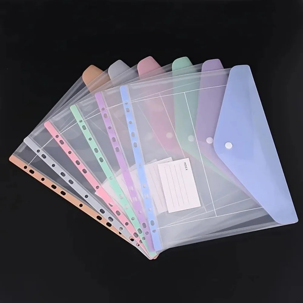A collection of colorful, transparent expandable binder pockets for ring binders displayed on a dark background.